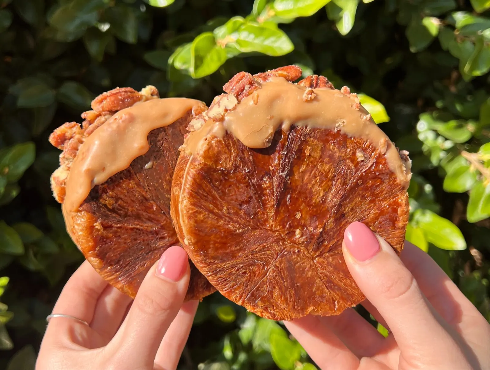 Two round caramel and pecan croissants.