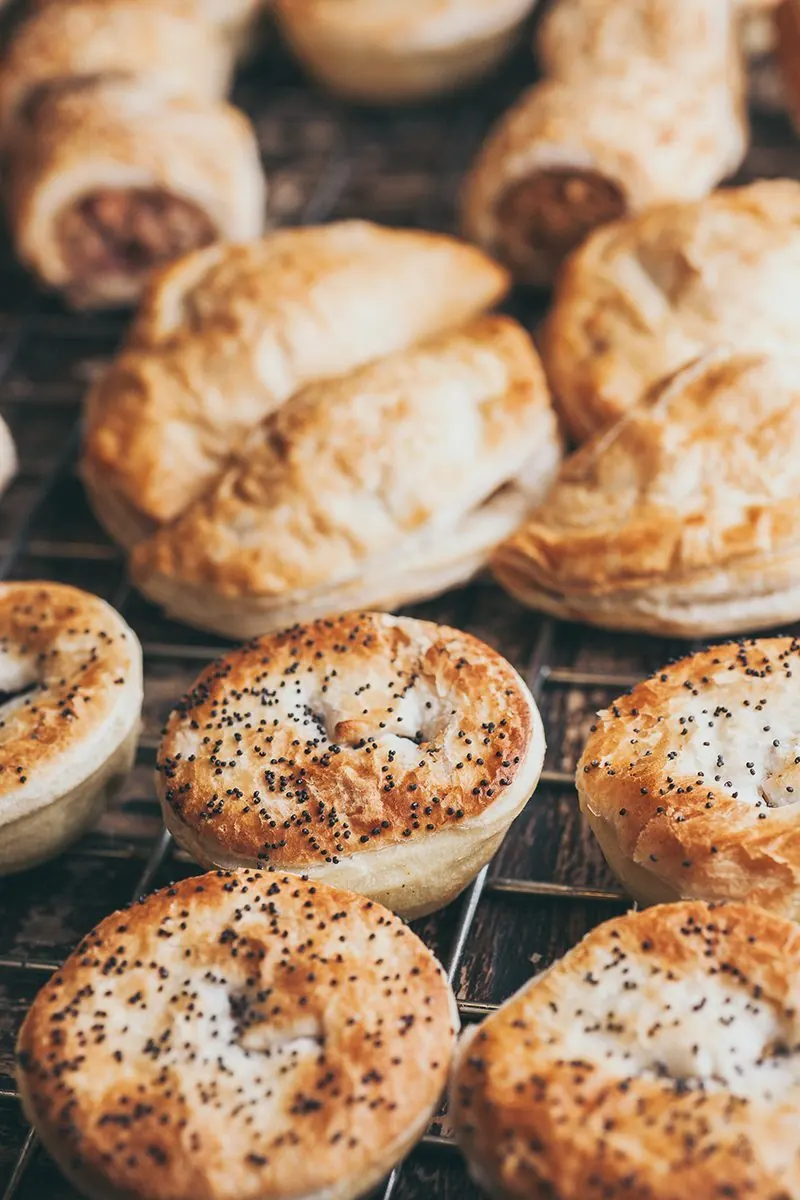 Racks of golden pies above trays of poppy seed bagels.